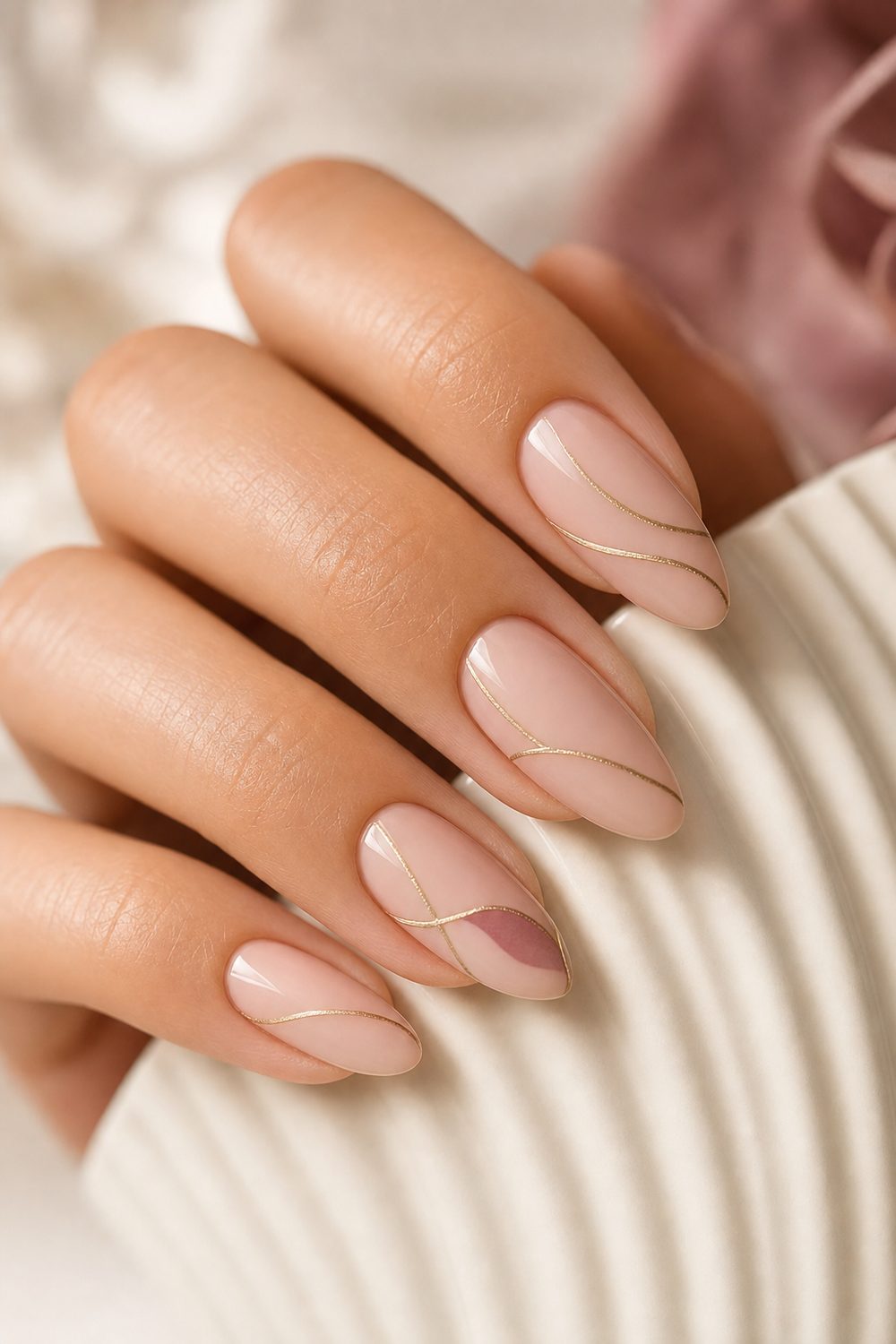 Nude blush nails with delicate hand-painted champagne gold line art and a small mauve accent